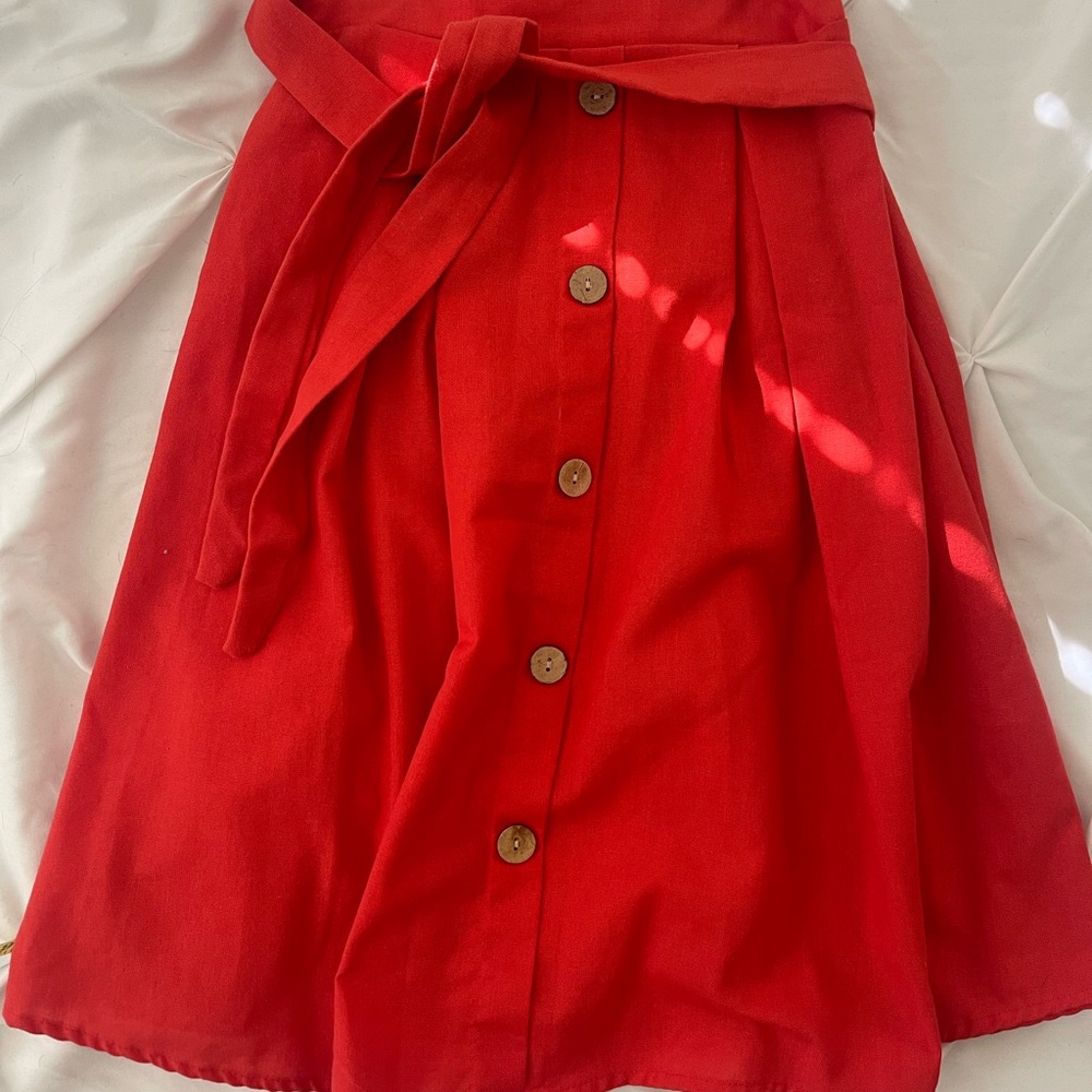 Coral/red skirt.